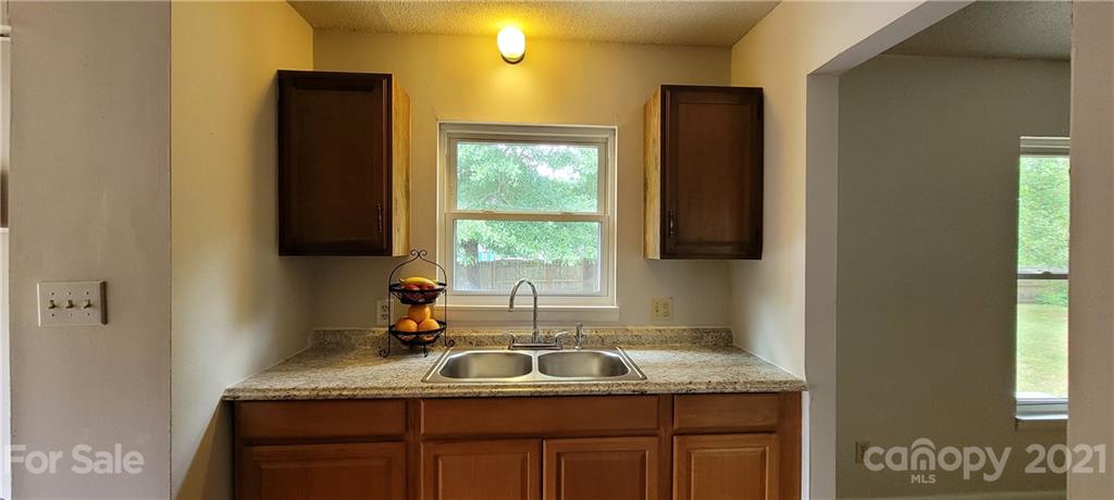 707 Finley Road Rock Hill, SC 29730 - Photo 10 of 26 a kitchen with granite countertop cabinets sink and window