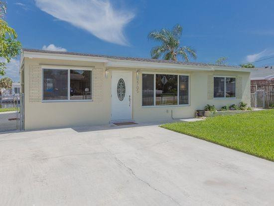 Undisclosed Address Hollywood, FL 33020 - Photo 2 of 8 front view of house with a yard and potted plants