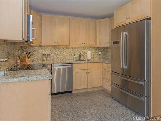 Undisclosed Address Hollywood, FL 33020 - Photo 3 of 8 a kitchen with stainless steel appliances granite countertop a refrigerator sink and white cabinets
