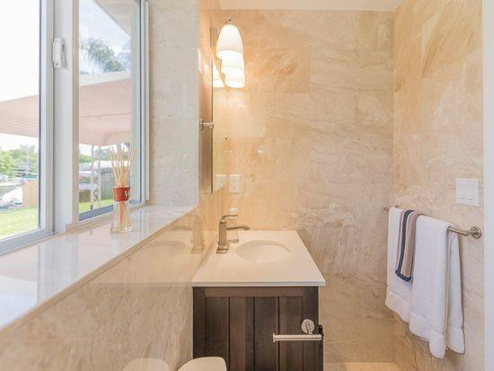Undisclosed Address Hollywood, FL 33020 - Photo 4 of 8 a bathroom with a sink and a large mirror