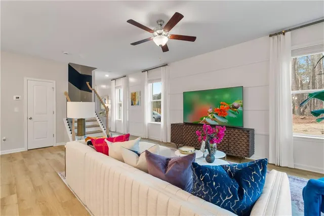 a living room with furniture and a flat screen tv