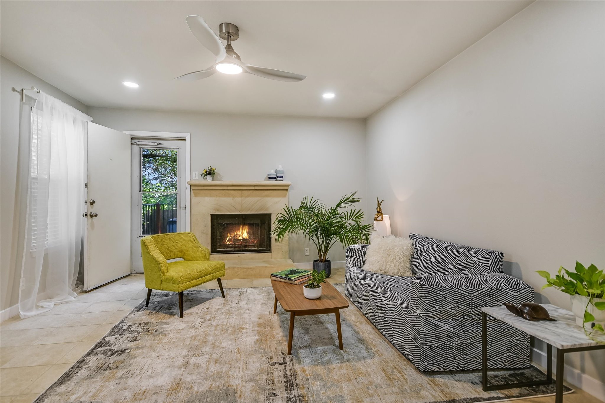 4902 Duval Road, Unit H1 Austin, TX 78727 - Photo 4 of 20 A comforting fireplace creates an inviting focal point in this well-lit living space.