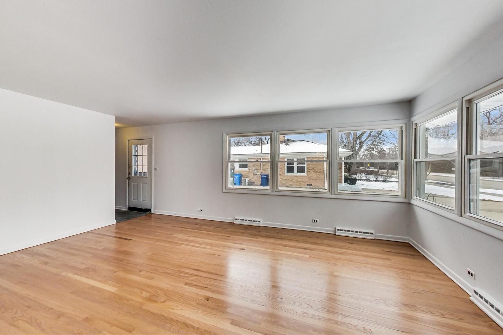 1022 Ridge Road Highland Park, IL 60035 - Photo 3 of 17 an empty room with wooden floor and windows