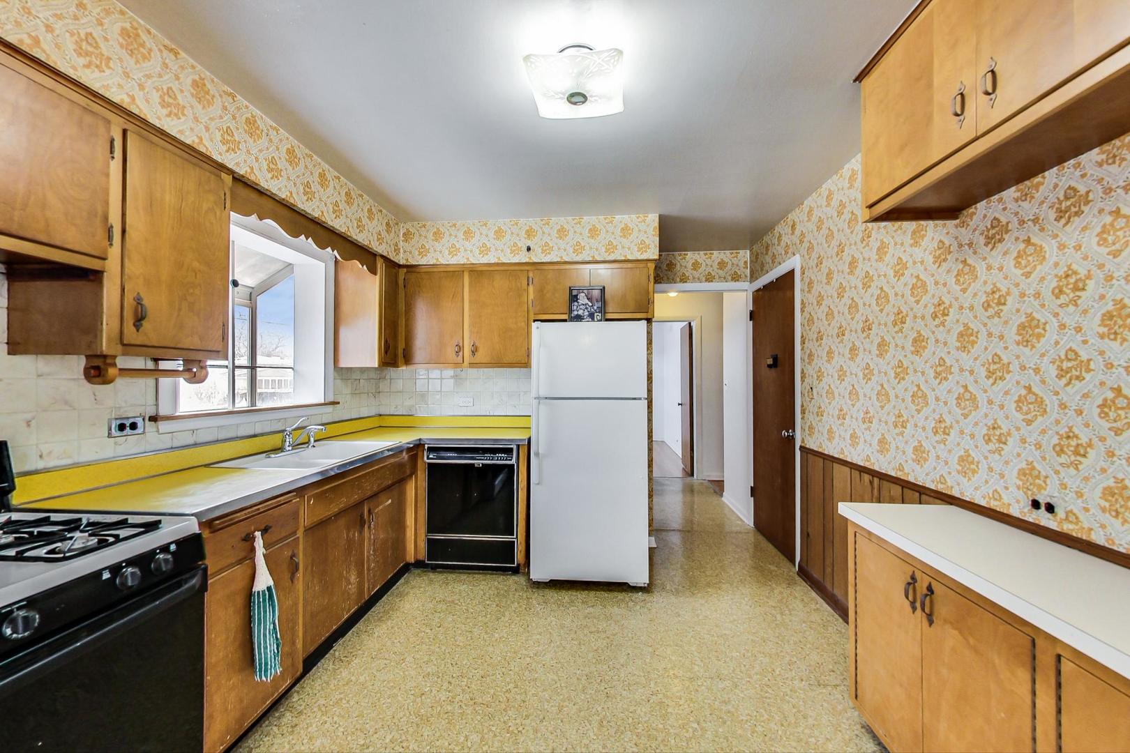 1022 Ridge Road Highland Park, IL 60035 - Photo 7 of 17 a kitchen with stainless steel appliances granite countertop a refrigerator a stove and a sink with wooden floor