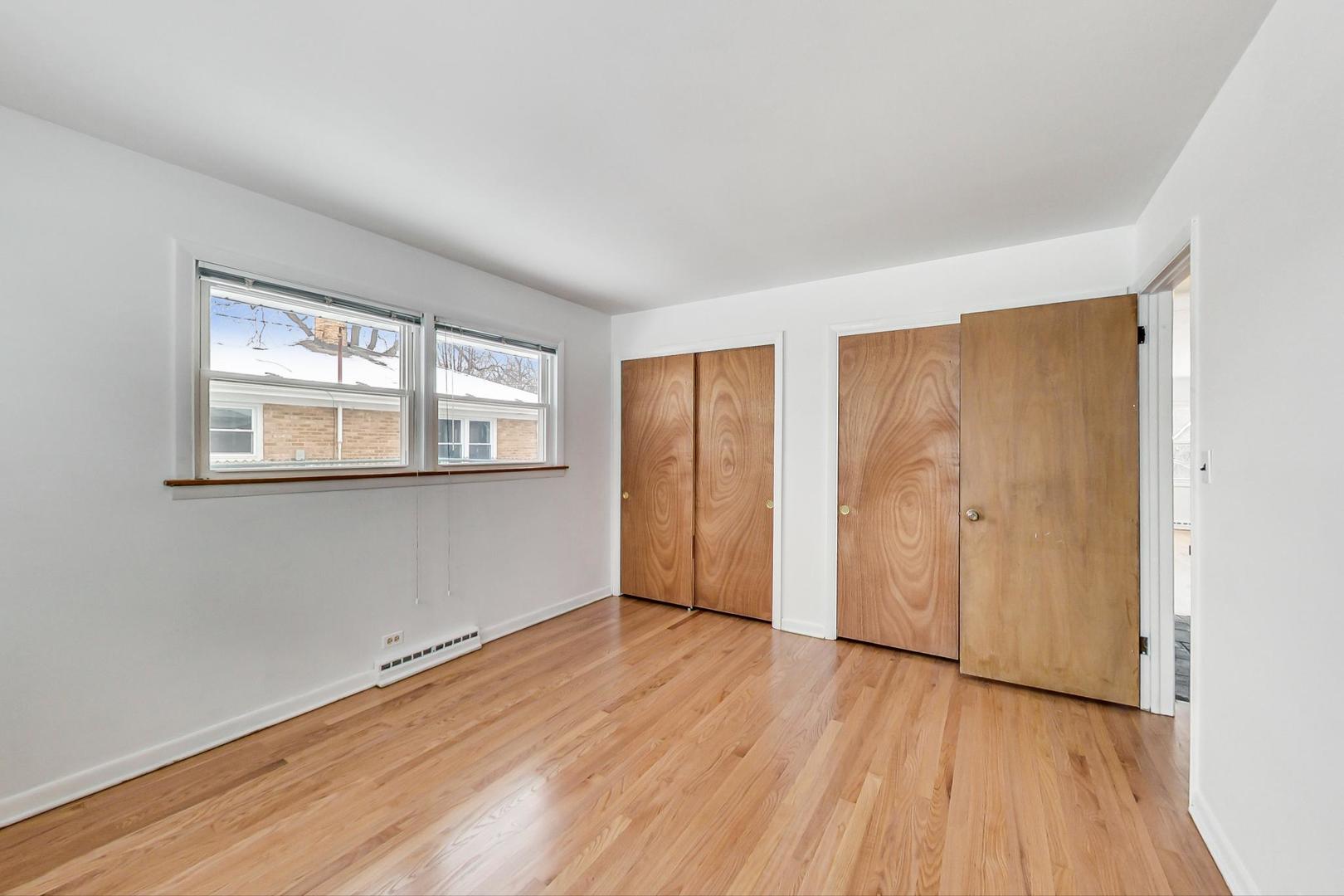 1022 Ridge Road Highland Park, IL 60035 - Photo 9 of 17 an empty room with wooden floor and windows