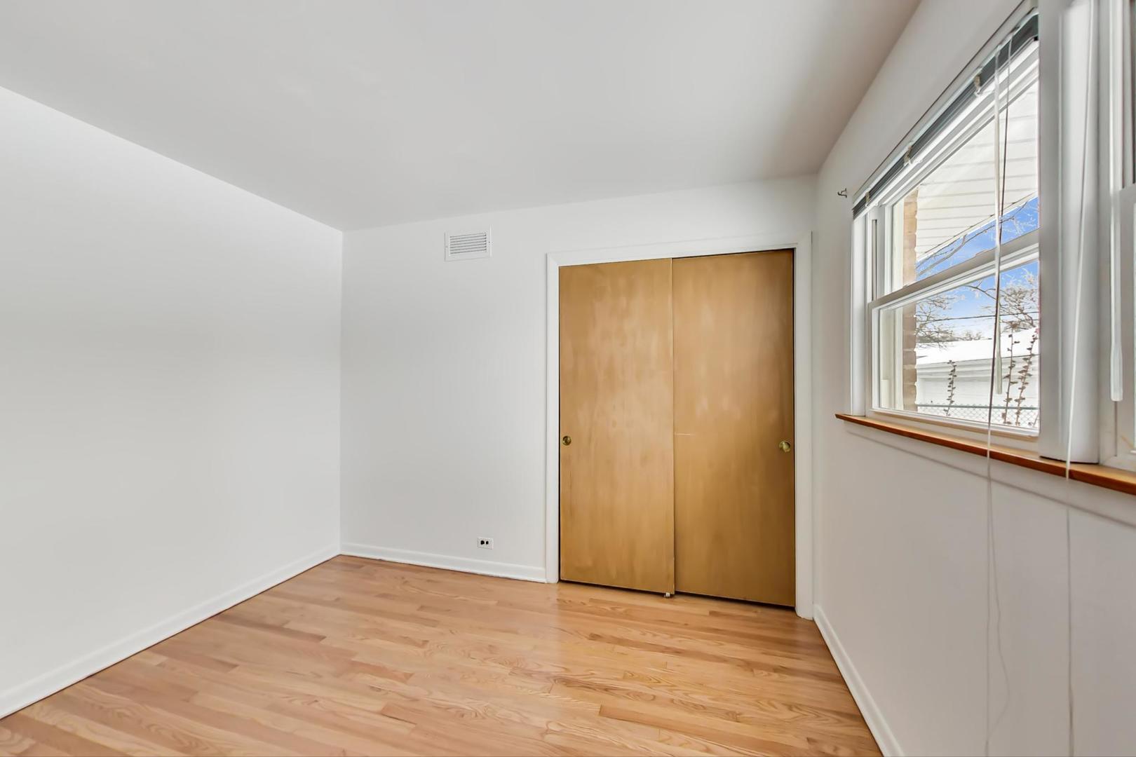 1022 Ridge Road Highland Park, IL 60035 - Photo 10 of 17 a view of an empty room with wooden floor and a window