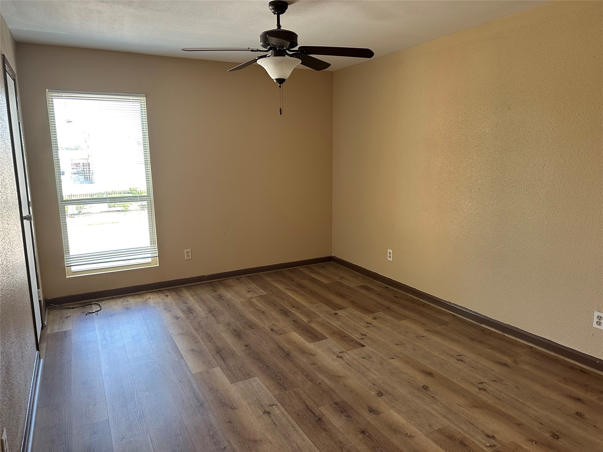 10100 South Gessner Road, Unit 414 Houston, TX 77071 - Photo 12 of 13 an empty room with wooden floor cabinet and windows