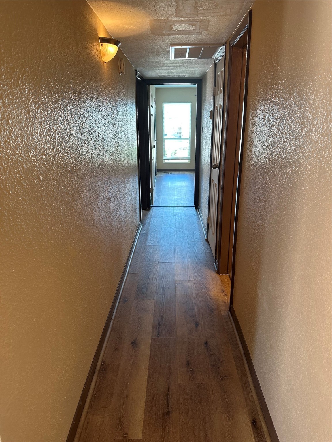 10100 South Gessner Road, Unit 414 Houston, TX 77071 - Photo 7 of 13 a view of a hallway with wooden floor