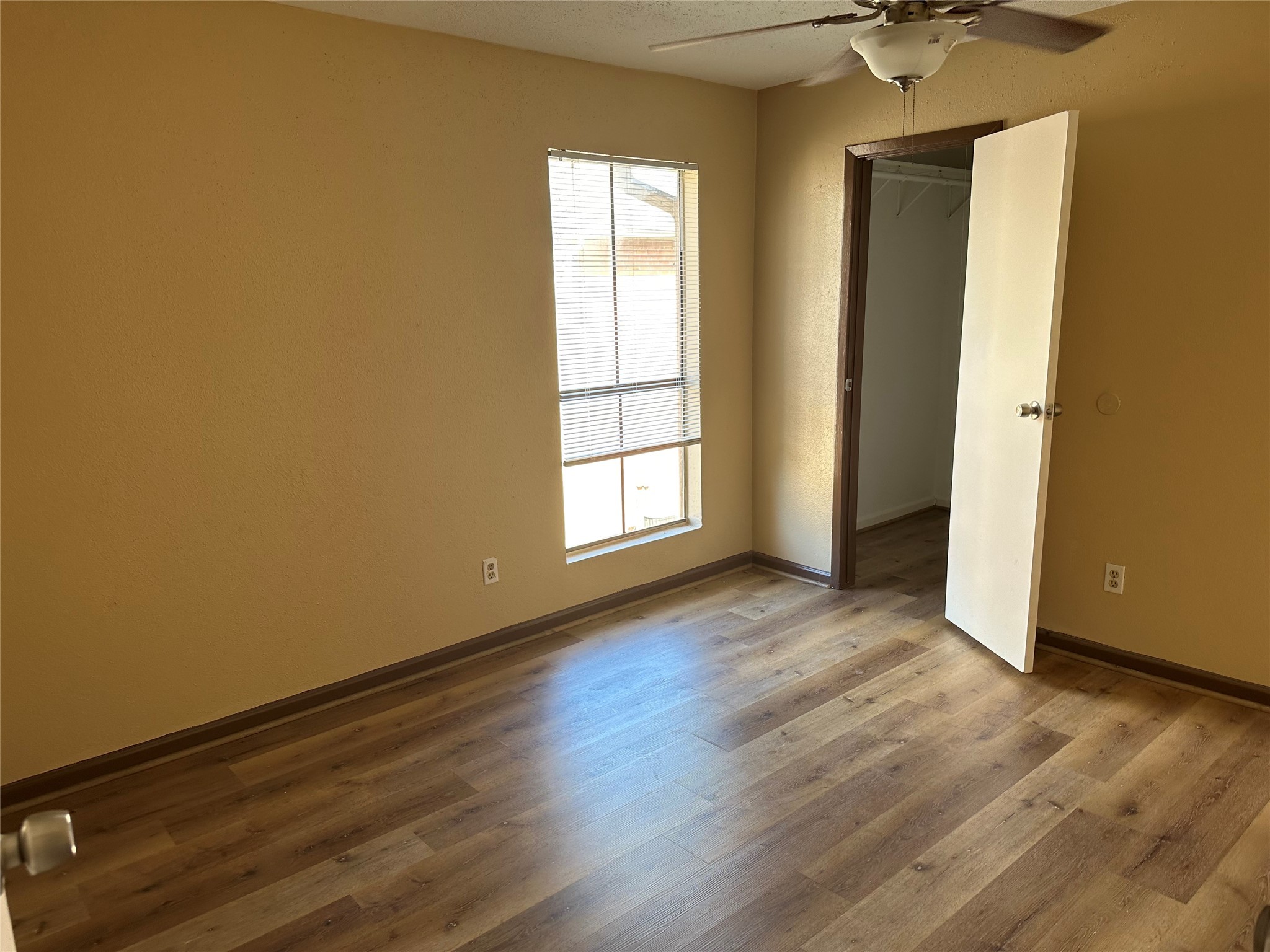 10100 South Gessner Road, Unit 414 Houston, TX 77071 - Photo 10 of 13 an empty room with wooden floor and windows