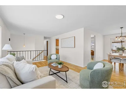 a dining room with furniture a chandelier and wooden floor