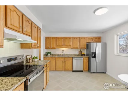 a kitchen with stainless steel appliances granite countertop a stove a sink and dishwasher