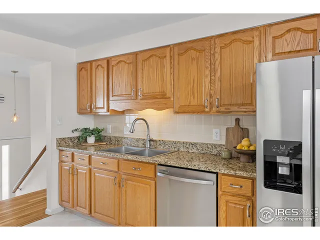 a kitchen with stainless steel appliances granite countertop a stove a sink dishwasher and a refrigerator