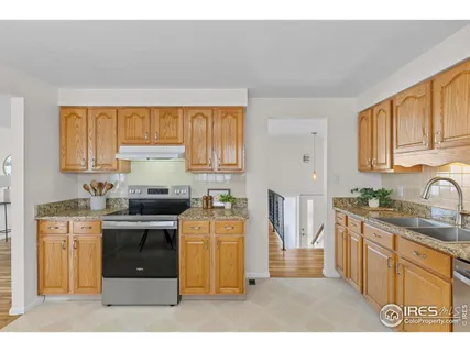 a living room with furniture and a refrigerator