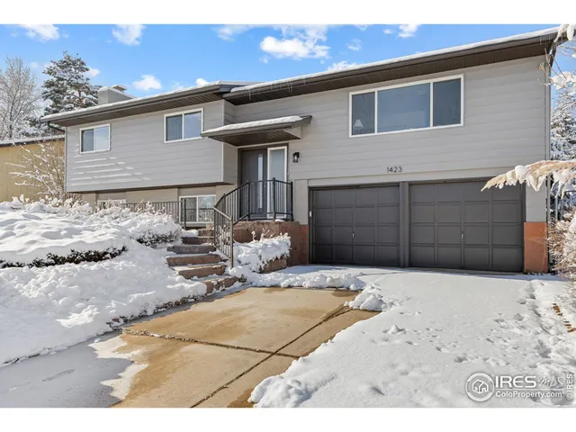 a view of a house with a yard covered in snow