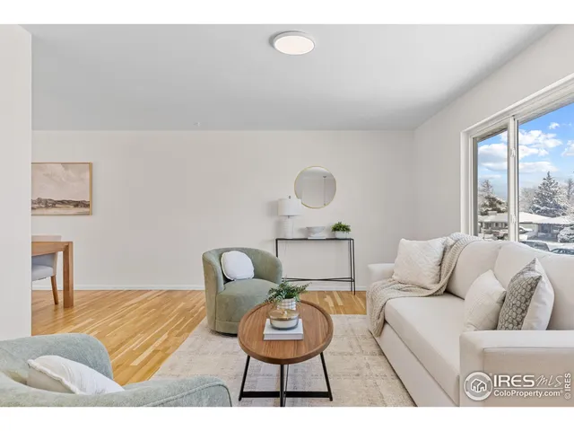 a living room with furniture a rug and a table