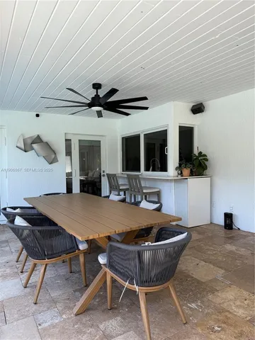 a living room with a table chairs and a table