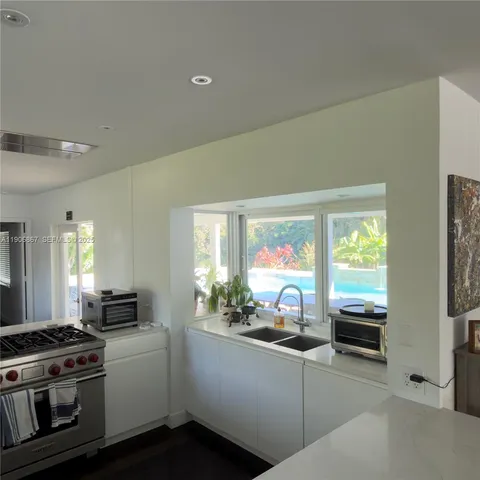 a kitchen with stainless steel appliances a stove a sink and a microwave