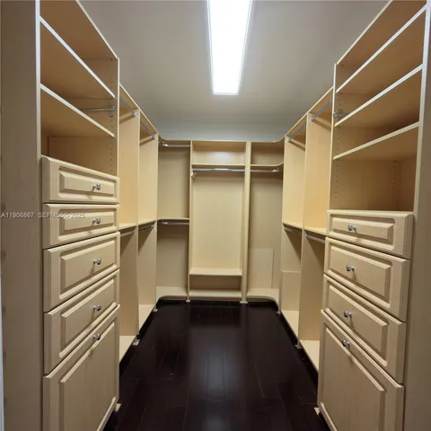 a view of walk in closet with empty racks