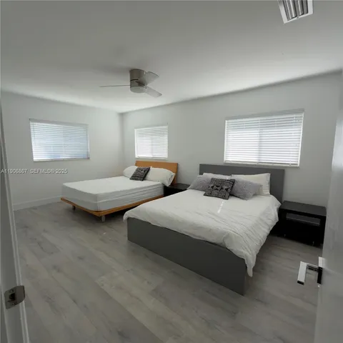 a bedroom with two beds and painted walls