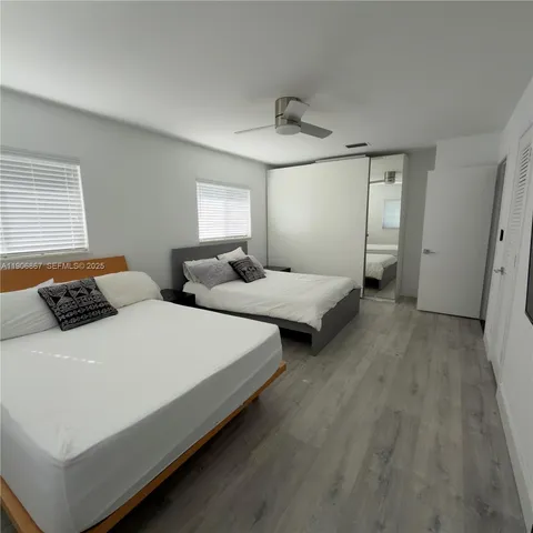 a bedroom with bed and window