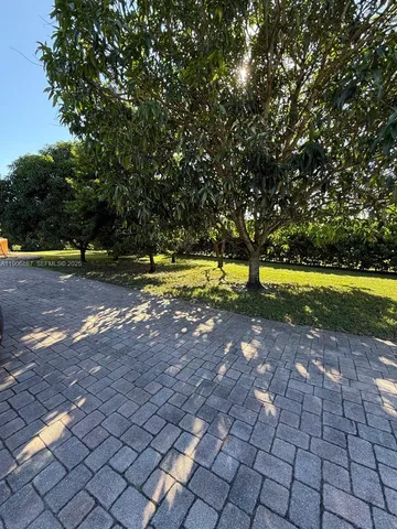 a view of yard with swimming pool and trees