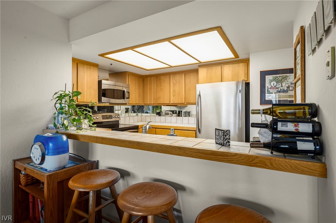 335 Ski Way, Unit 337 Incline Village, NV 89451 - Photo 12 of 23 a kitchen with stainless steel appliances granite countertop a sink and a refrigerator