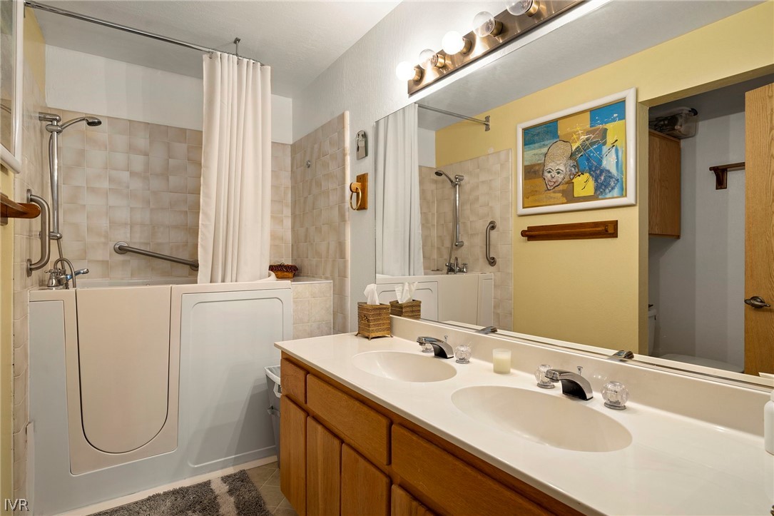 335 Ski Way, Unit 337 Incline Village, NV 89451 - Photo 19 of 23 a bathroom with a sink a mirror a glass door and shower