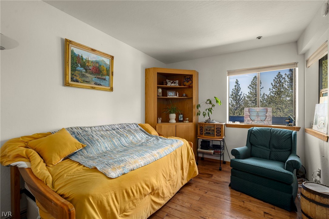 335 Ski Way, Unit 337 Incline Village, NV 89451 - Photo 20 of 23 a bedroom with a bed a couch and a large window
