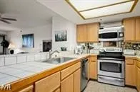 a kitchen with stainless steel appliances granite countertop a stove and a sink