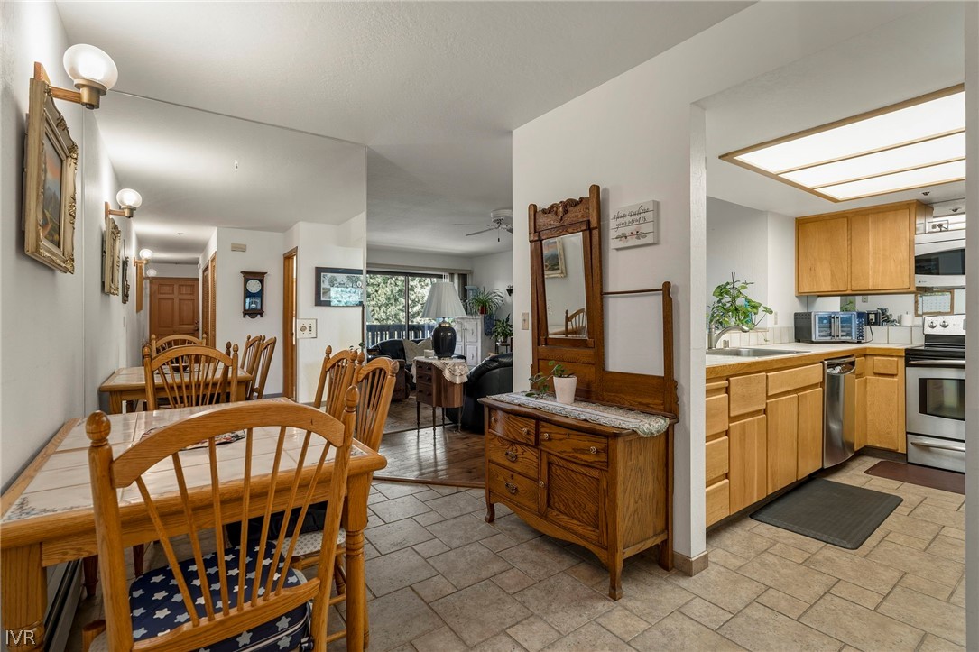 335 Ski Way, Unit 337 Incline Village, NV 89451 - Photo 8 of 23 a kitchen with stainless steel appliances granite countertop a dining table chairs and a refrigerator