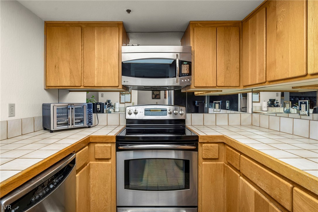 335 Ski Way, Unit 337 Incline Village, NV 89451 - Photo 10 of 23 a kitchen with stainless steel appliances granite countertop a stove a sink and a microwave