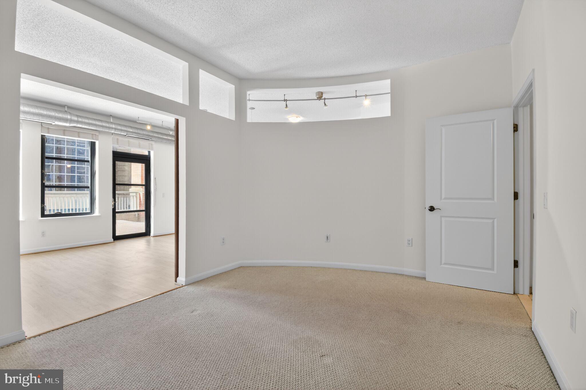 1390 Kenyon Street Northwest, Unit 319 Washington, DC 20010 - Photo 16 of 38 wooden floor and windows in an empty room