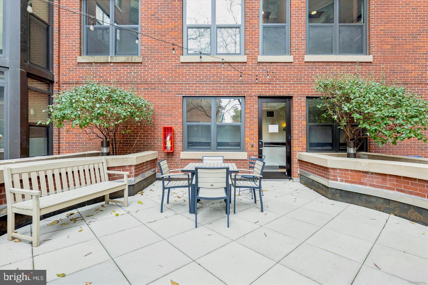 1390 Kenyon Street Northwest, Unit 319 Washington, DC 20010 - Photo 32 of 38 a view of a patio with chairs and a table