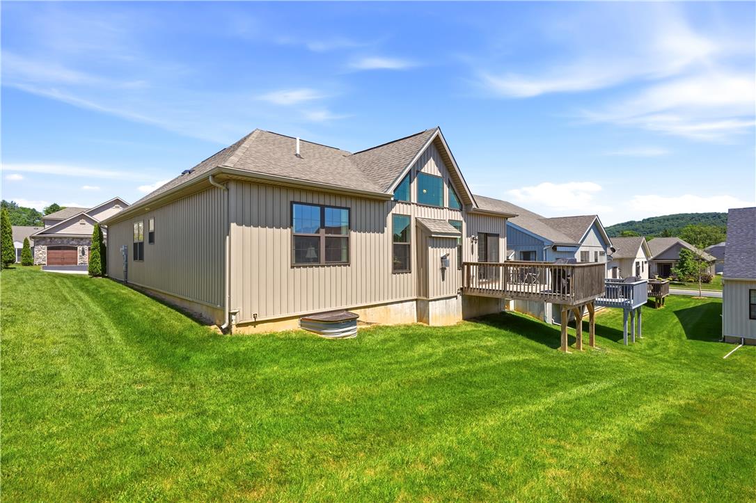 4120 Eveningstar Road Emmaus, PA 18049 - Photo 50 of 62 A well-maintained lawn stretches beside a modern residence featuring a spacious deck for outdoor enjoyment.