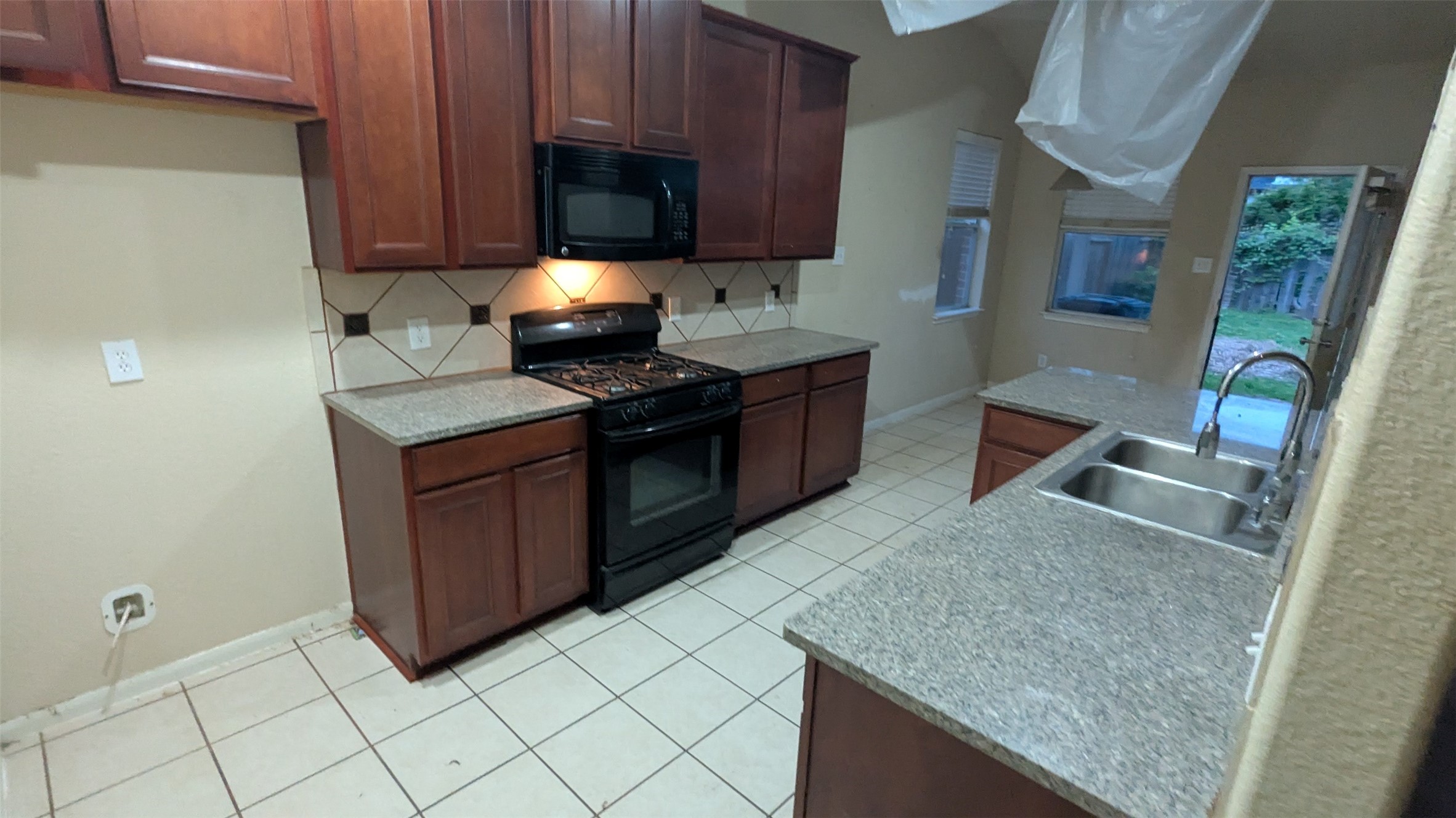 21850 Catoosa Drive Spring, TX 77388 - Photo 7 of 15 a kitchen with stainless steel appliances granite countertop a stove a sink and a microwave