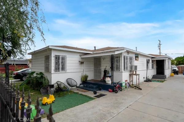 a view of a house with yard and sitting area