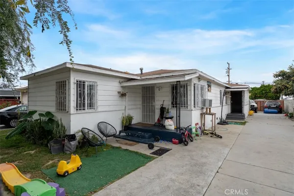 a front view of a house with yard and furniture