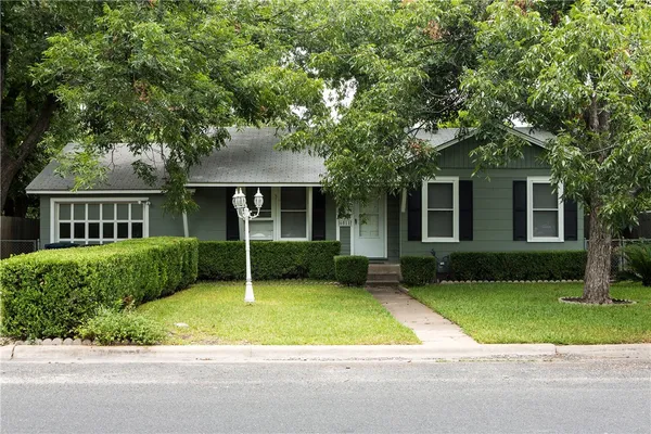 front view of a house next to a yard