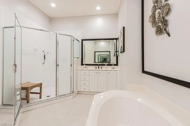 a spacious bedroom with a bed and a flat screen tv