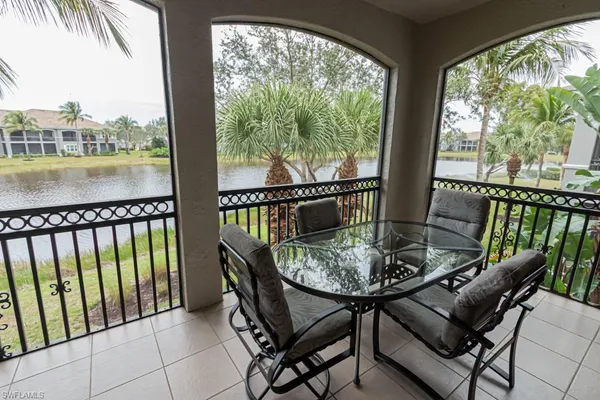 a view of a balcony with chairs and a table