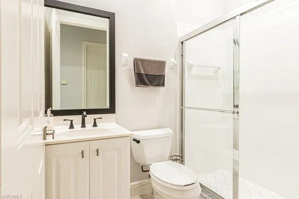a bathroom with a toilet a sink and a mirror