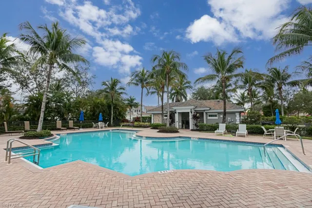 a view of a house with swimming pool and sitting area