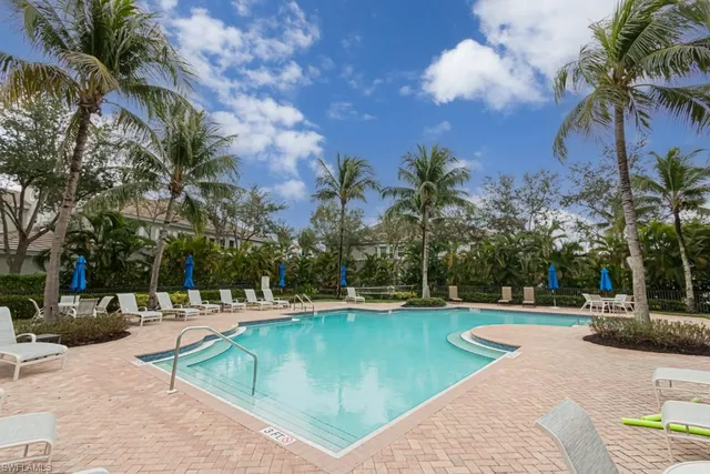 a swimming pool with outdoor seating and yard
