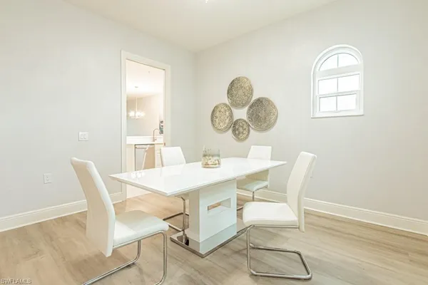 a view of a dining room with a table and chairs