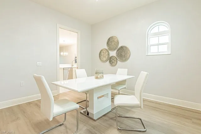 a view of a dining room with a table and chairs