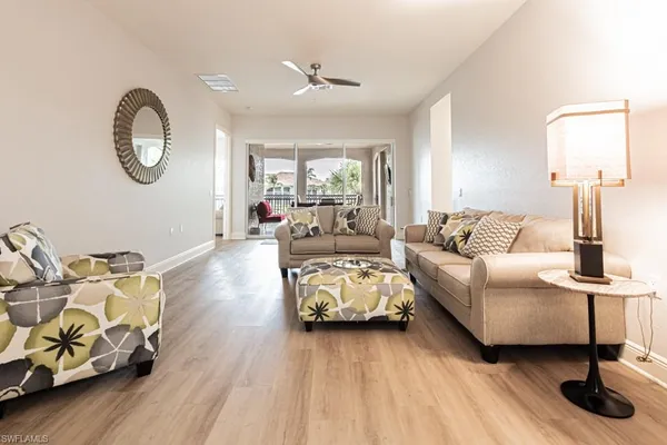 a living room with furniture and a wooden floor