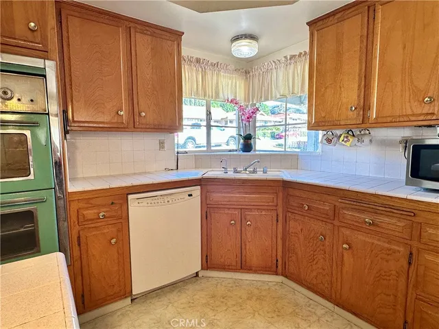a kitchen with stainless steel appliances granite countertop cabinets and window