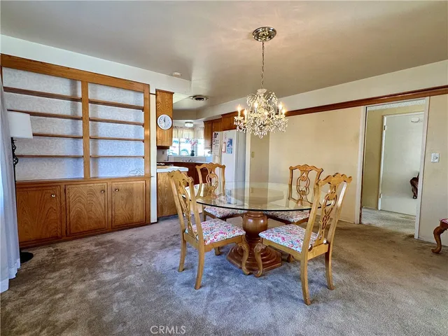a view of a dining room with furniture and chandelier