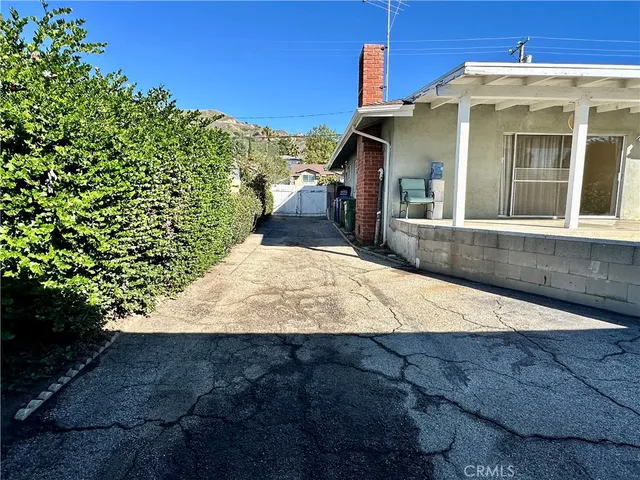 a view of a house with a large tree