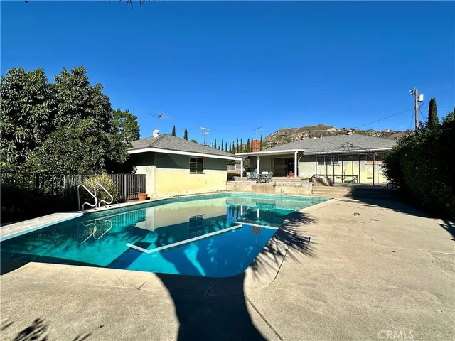 swimming pool view with a seating space